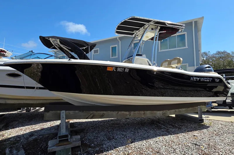 Slide: The Image of 2019 Key West 203 FS boat on display, black hull, parked outdoors. - 17