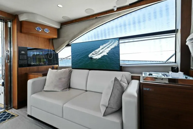 Slide: The Image of Luxurious 2016 Princess 60 Flybridge yacht interior with modern sofa and large window view. - 15