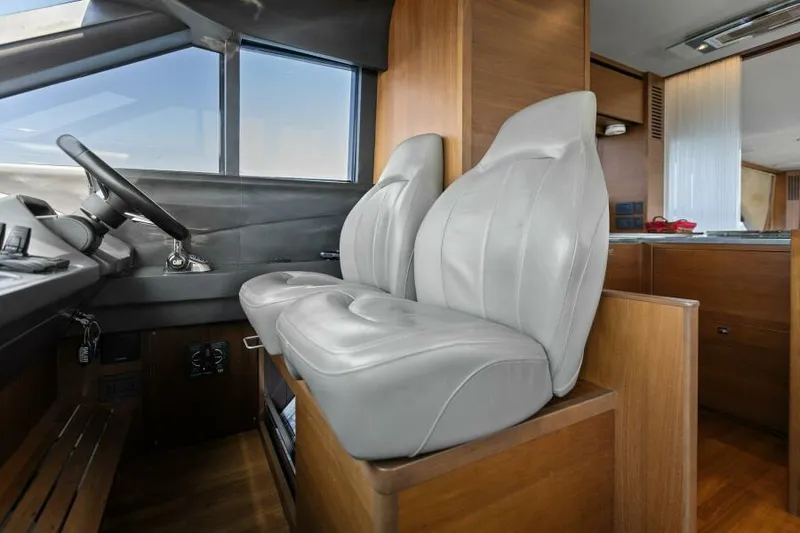 Slide: The Image of Interior of 2016 Princess 60 Flybridge yacht with leather seats and wooden accents. - 27