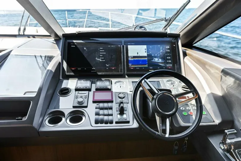 Slide: The Image of Helm of 2016 Princess 60 Flybridge yacht with modern navigation controls. - 31