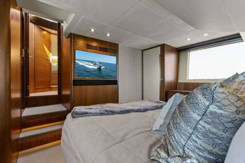 Slide: The Image of Luxurious 2016 Princess 60 Flybridge yacht bedroom with elegant decor and large window view. - 33