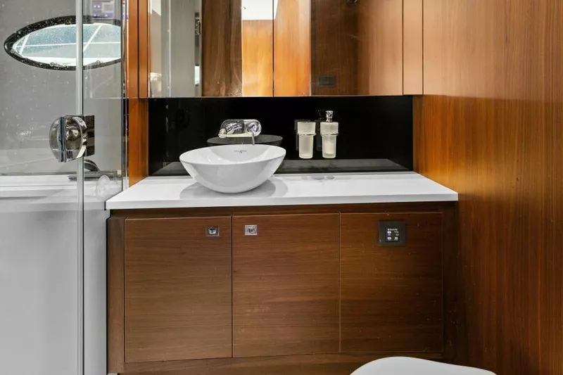 Slide: The Image of Luxurious bathroom on 2016 Princess 60 Flybridge yacht with modern sink and wooden cabinetry. - 38