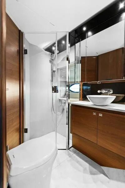 Slide: The Image of Luxurious bathroom on 2016 Princess 60 Flybridge yacht with modern fixtures and wood accents. - 46