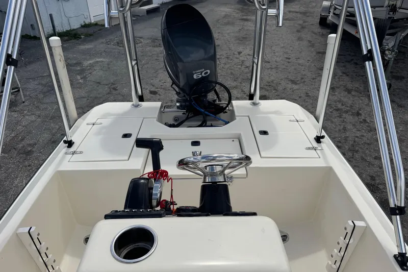 Slide: The Image of 1991 Hoog Comet 14 boat interior with Yamaha 60 engine, steering wheel, and control panel. - 12