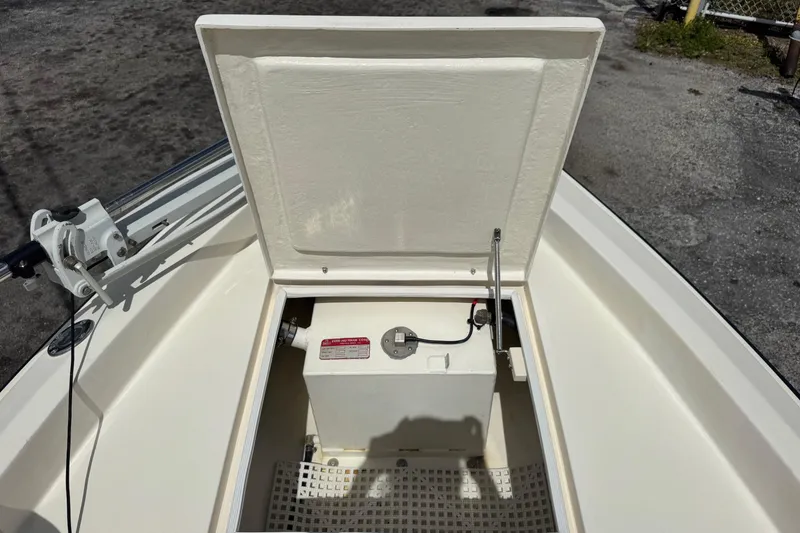Slide: The Image of 1991 Hoog Comet 14 boat storage compartment with open hatch, revealing internal components. - 16