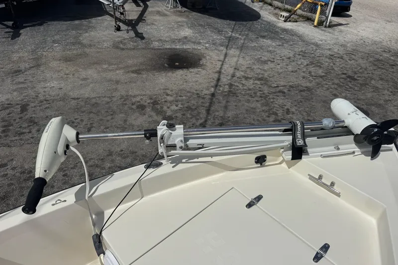 Slide: The Image of Trolling motor mounted on a 1991 Hoog Comet 14 boat, parked on a concrete surface. - 18
