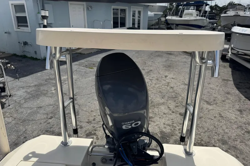 Slide: The Image of 1991 Hoog Comet 14 boat with Yamaha 60 engine, docked near other boats. - 22