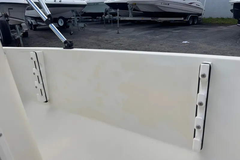 Slide: The Image of Interior view of a 1991 Hoog Comet 14 boat, showcasing clean white paneling. - 24