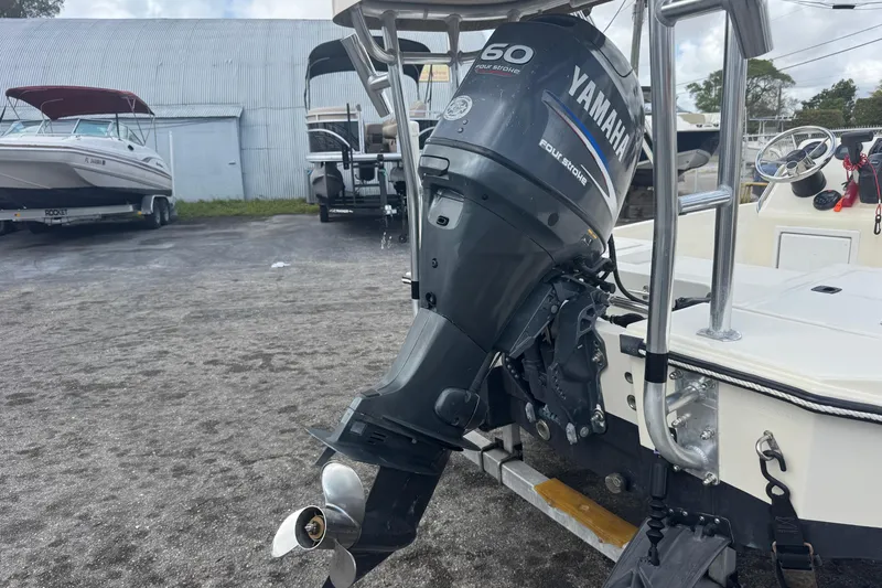 Slide: The Image of 1991 Hoog Comet 14 boat with Yamaha 60 four-stroke outboard motor in a marina. - 26