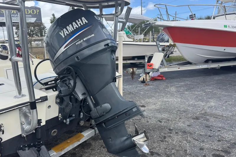 Slide: The Image of Outboard Yamaha motor on a 1991 Hoog Comet 14 boat, parked on a trailer. - 28