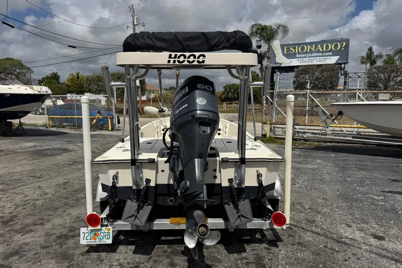 Slide: The Image of 1991 Hoog Comet 14 boat with Yamaha 60 engine, parked outdoors. - 4