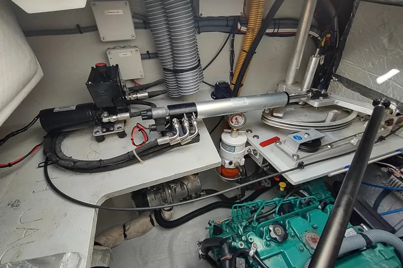 Slide: The Image of Engine room of a 2020 Outremer 51 catamaran, showcasing hydraulic and mechanical components. - 108