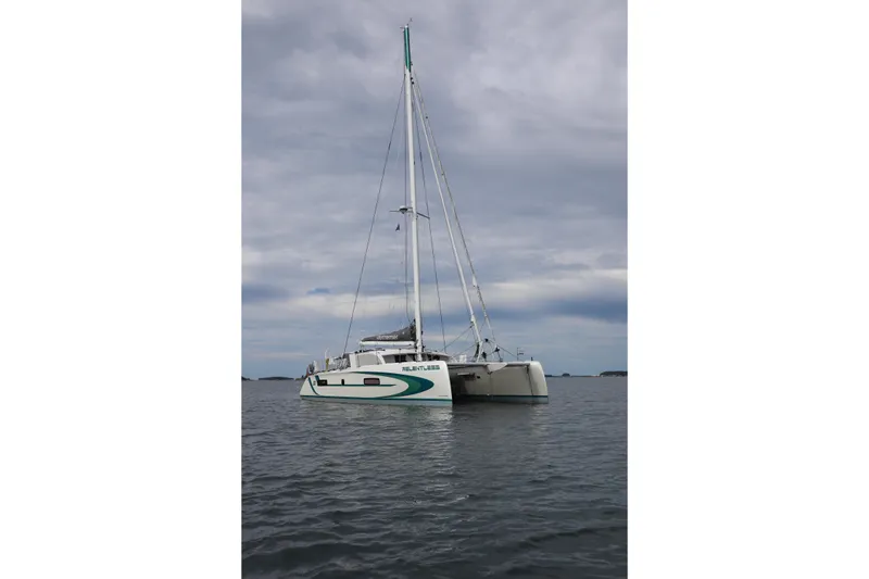 Slide: The Image of 2020 Outremer 51 catamaran sailing on calm waters under cloudy skies. - 11
