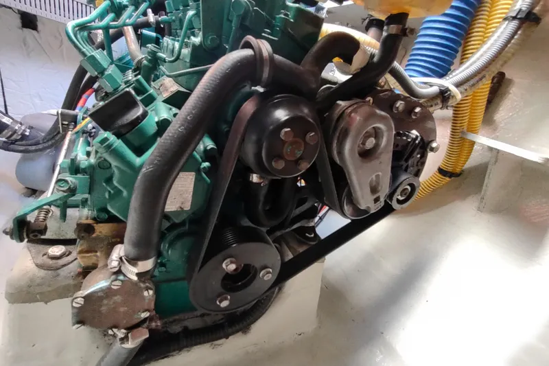 Slide: The Image of Engine compartment of a 2020 Outremer 51 catamaran, showcasing mechanical components and hoses. - 111