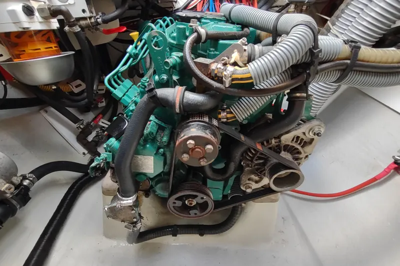 Slide: The Image of Engine compartment of a 2020 Outremer 51 catamaran, showcasing mechanical components and hoses. - 112