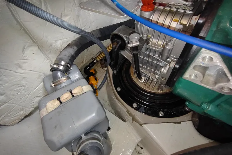 Slide: The Image of Engine compartment of a 2020 Outremer 51 catamaran, showcasing mechanical components and hoses. - 115