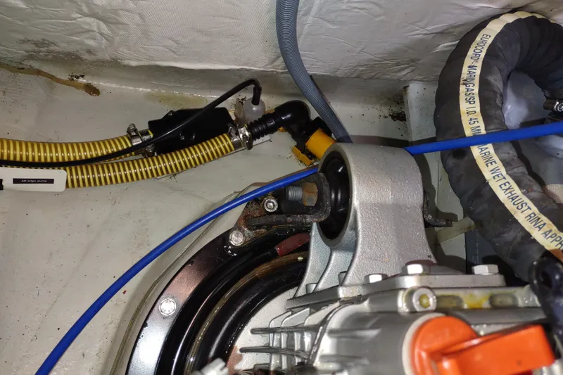 Slide: The Image of Engine compartment of a 2020 Outremer 51, featuring hoses and mechanical components. - 116