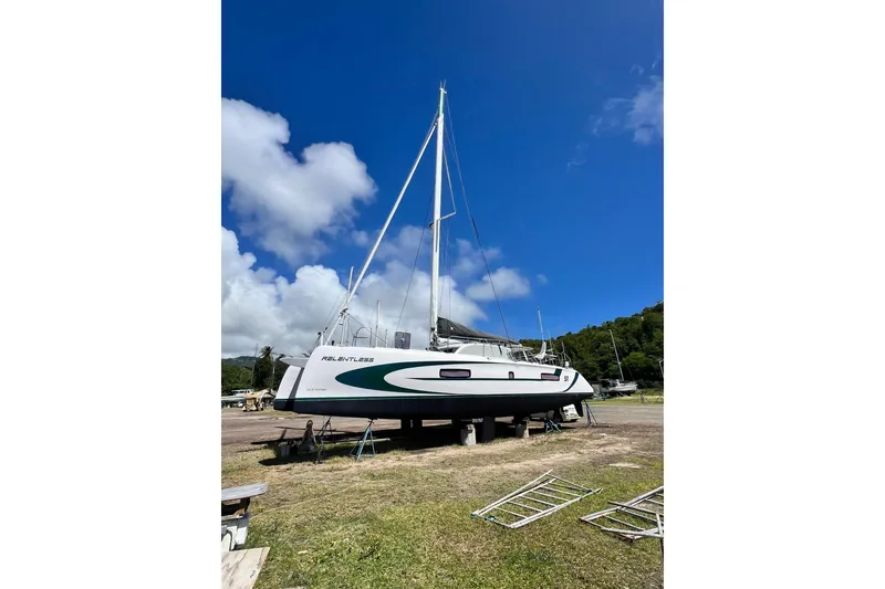 Slide: The Image of 2020 Outremer 51 catamaran on land under clear blue sky. - 12