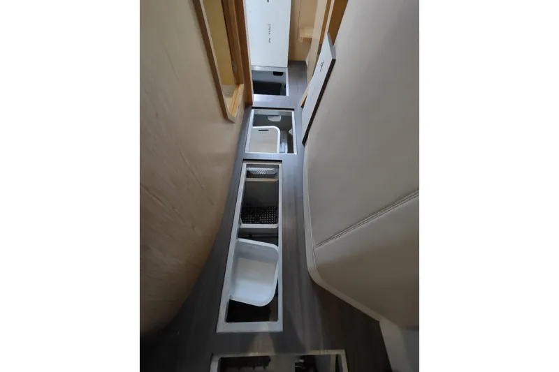 Slide: The Image of Interior view of 2020 Outremer 51 yacht with open floor storage compartments. - 126