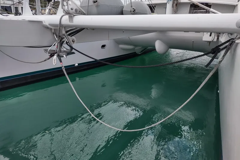 Slide: The Image of Outremer 51 catamaran, 2020 model, docked with visible rigging and turquoise water. - 131