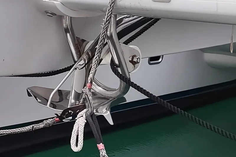 Slide: The Image of Outremer 51 (2020) yacht anchor and ropes detail in marina setting. - 132