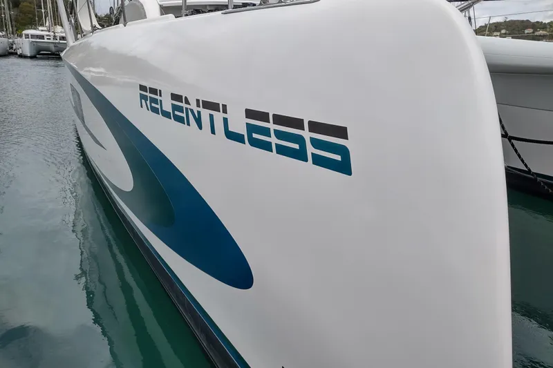 Slide: The Image of Outremer 51 catamaran, 2020 model, with "Relentless" branding on the hull. - 134