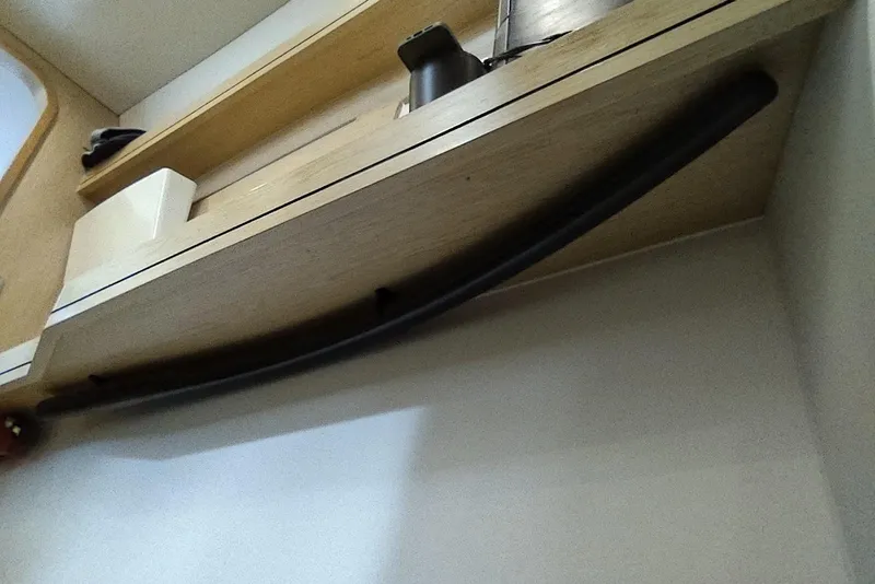 Slide: The Image of Interior shelf detail on 2020 Outremer 51 yacht, featuring wooden design and storage items. - 141