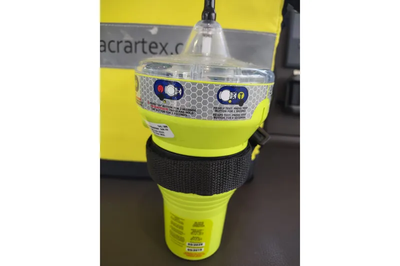 Slide: The Image of Yellow emergency beacon device on Outremer 51, 2020 model, with safety instructions visible. - 153