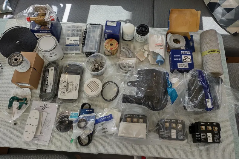 Slide: The Image of Assorted spare parts and tools for a 2020 Outremer 51 catamaran, neatly organized. - 162