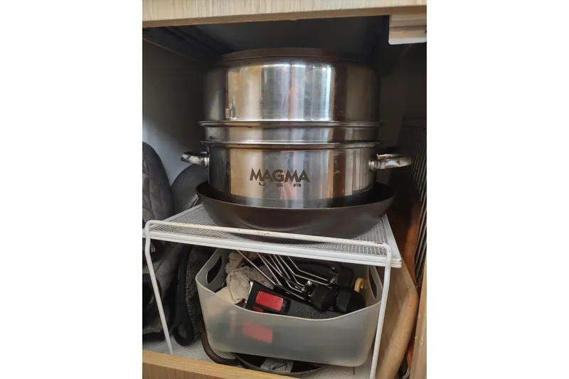 Slide: The Image of Stainless steel Magma cookware in a cabinet on an Outremer 51, 2020 model. - 169