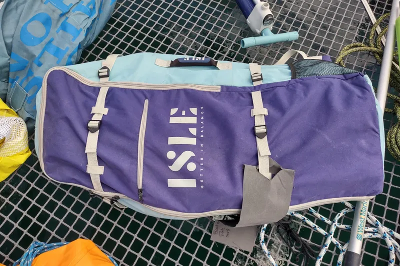 Slide: The Image of Bag on Outremer 51 catamaran deck, featuring "ISLE" branding, ropes, and equipment. - 176
