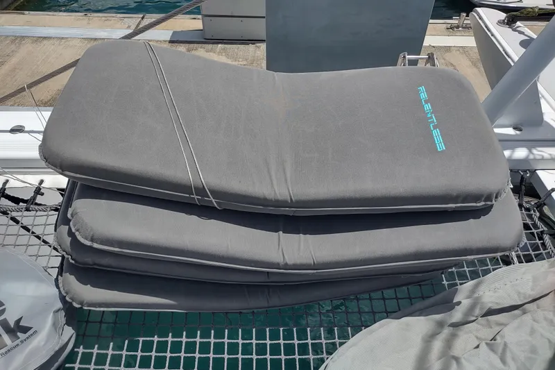 Slide: The Image of Stacked gray cushions on a 2020 Outremer 51 catamaran deck. - 179