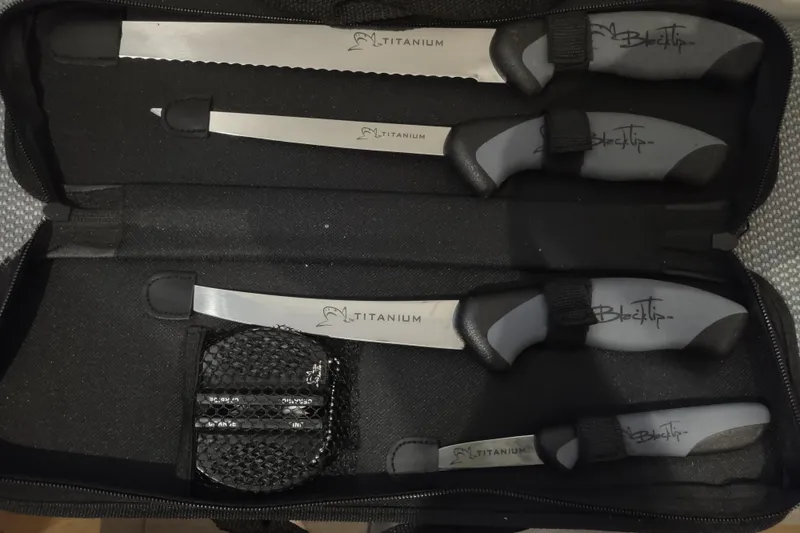 Slide: The Image of Knife set with titanium blades and ergonomic handles in a black case. - 182
