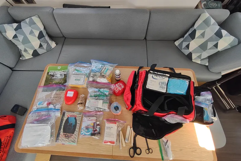 Slide: The Image of First aid kit and medical supplies on a table inside a 2020 Outremer 51 yacht. - 196