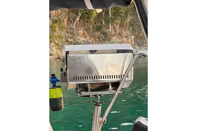 Slide: The Image of Stainless steel grill on 2020 Outremer 51 yacht, with scenic coastal backdrop. - 199