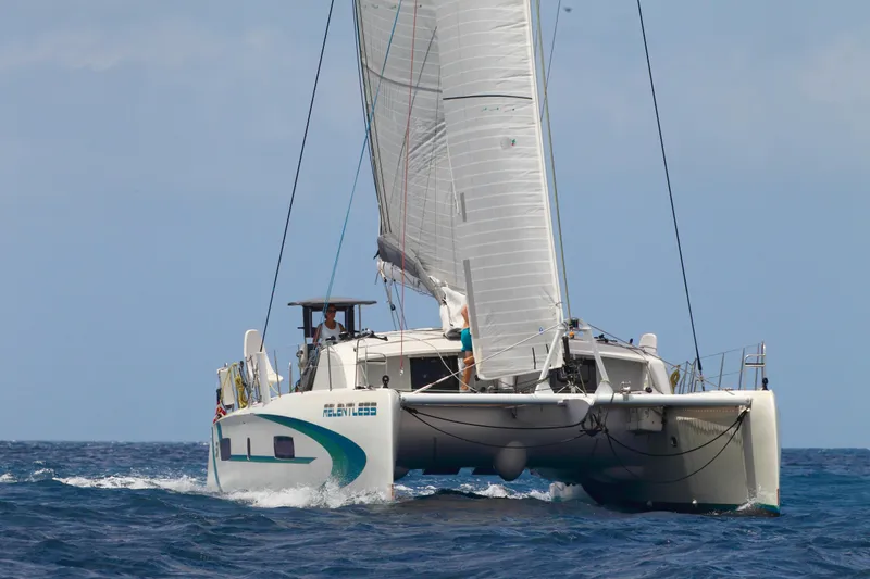 Slide: The Image of 2020 Outremer 51 catamaran sailing on open sea with full sails. - 2
