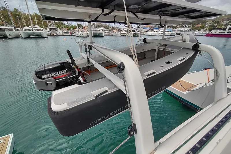 Slide: The Image of Outremer 51 catamaran with Mercury engine tender, docked in a marina, 2020 model. - 20