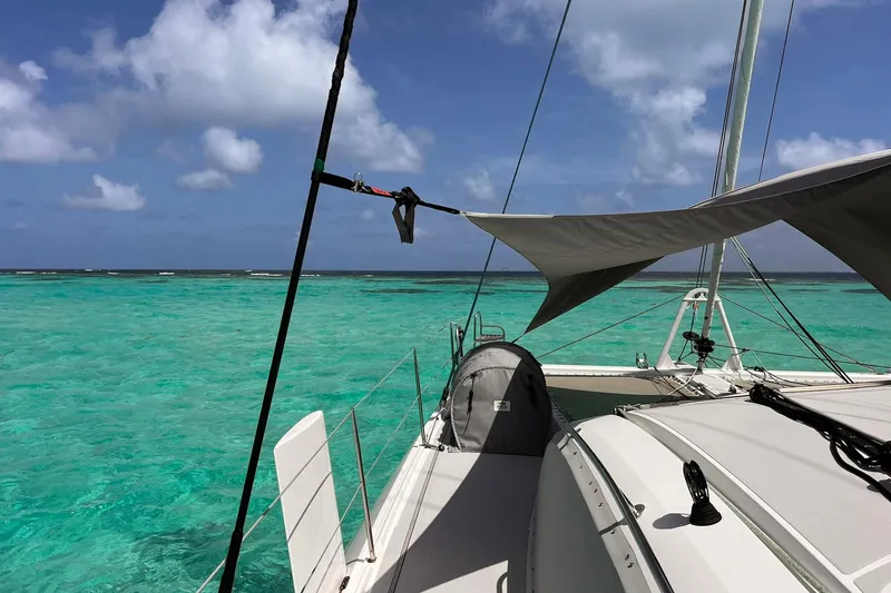 Slide: The Image of Outremer 51 catamaran sailing in turquoise waters, 2020 model, under clear blue skies. - 202