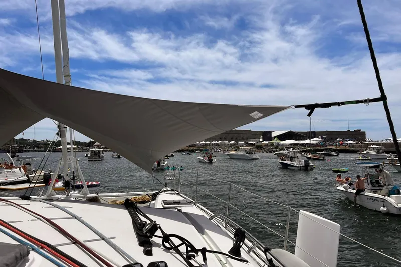 Slide: The Image of Sailboats and motorboats in a busy harbor, viewed from a 2020 Outremer 51 catamaran. - 205