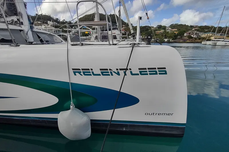 Slide: The Image of 2020 Outremer 51 catamaran "Relentless" docked in a scenic marina. - 22