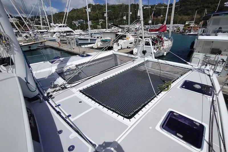 Slide: The Image of Outremer 51 catamaran, 2020 model, docked at a marina with clear skies. - 29