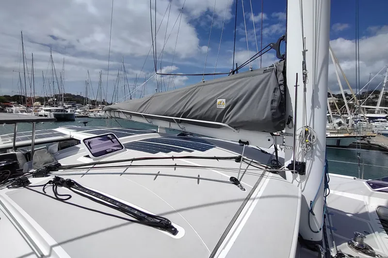Slide: The Image of 2020 Outremer 51 sailboat docked in marina, featuring sleek deck and rigging. - 30