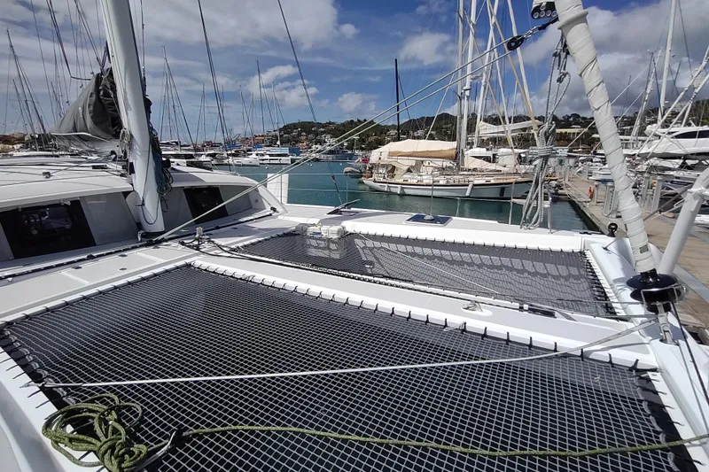 Slide: The Image of 2020 Outremer 51 catamaran docked at marina, showcasing deck and rigging. - 31