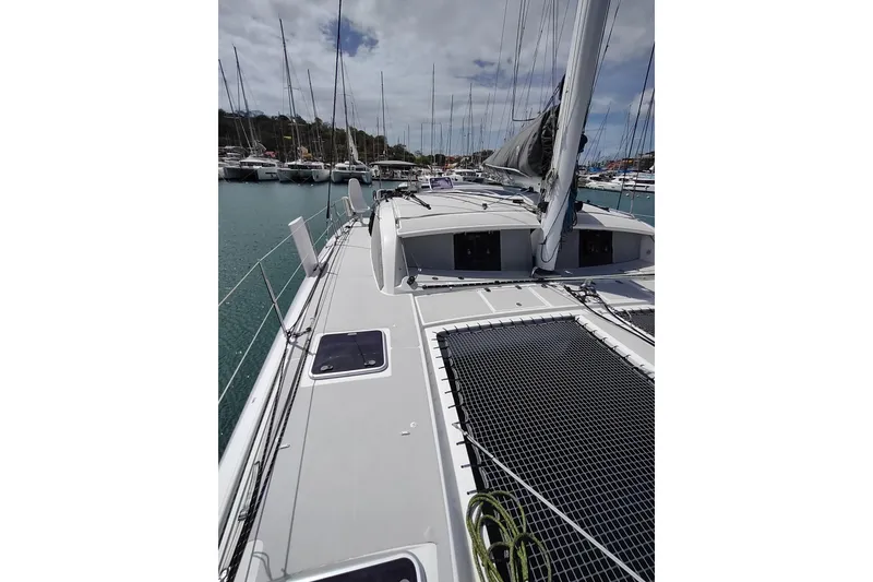 Slide: The Image of 2020 Outremer 51 catamaran docked in marina, showcasing deck and rigging. - 33