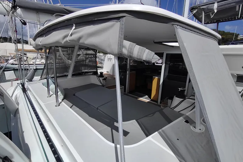 Slide: The Image of 2020 Outremer 51 catamaran with shaded cockpit and open interior view at marina. - 34
