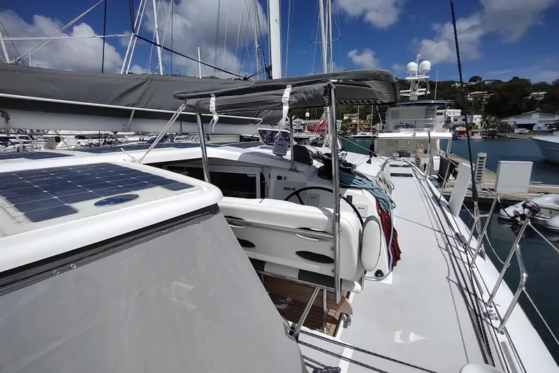 Slide: The Image of 2020 Outremer 51 catamaran docked, featuring solar panels and sleek design under a blue sky. - 35