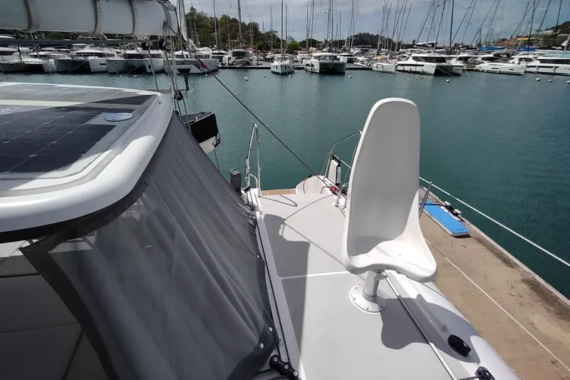 Slide: The Image of 2020 Outremer 51 catamaran docked at marina, featuring sleek deck and modern design. - 37