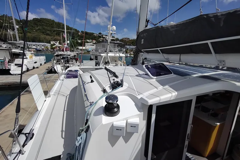 Slide: The Image of 2020 Outremer 51 catamaran docked at marina, showcasing deck and rigging. - 38