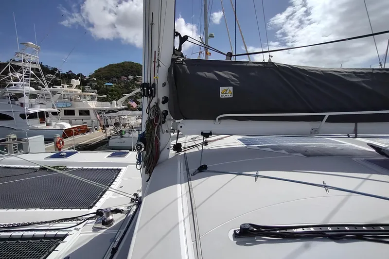Slide: The Image of 2020 Outremer 51 catamaran docked at marina under clear blue sky. - 40