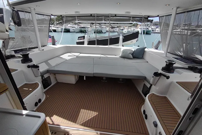Slide: The Image of Spacious 2020 Outremer 51 catamaran cockpit with comfortable seating and marina view. - 44